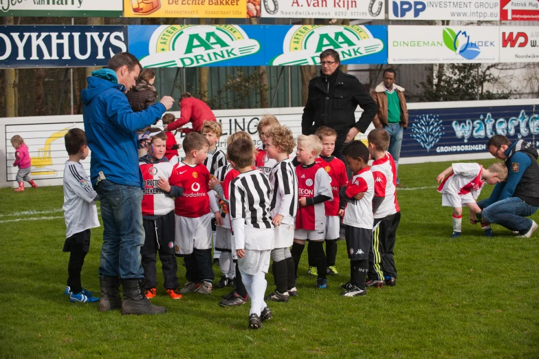 coach coaching children soccer during a game