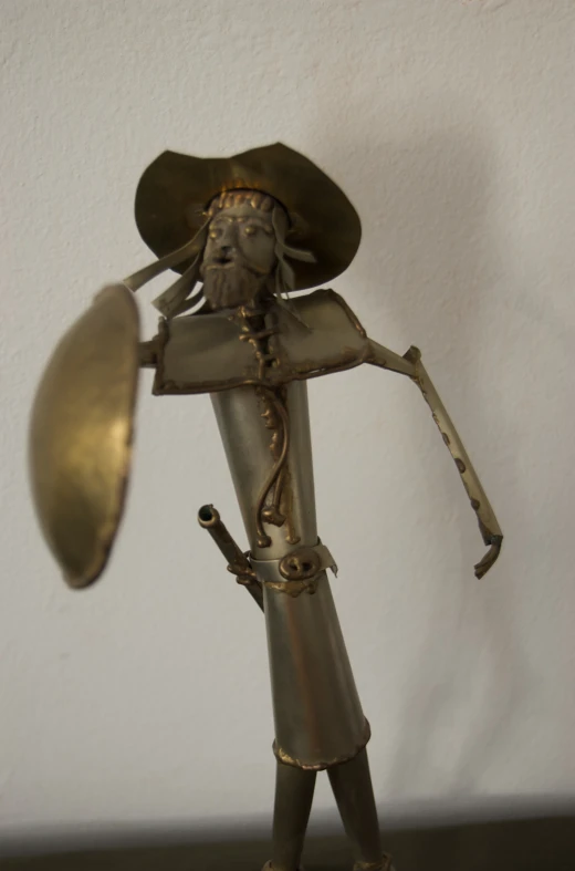 a metal statue holding up a ss plate