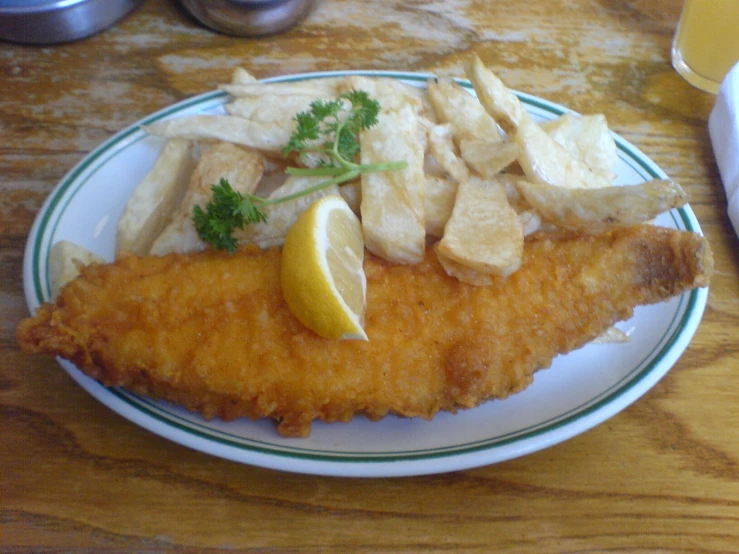 fish with parsley and lemon served on a white plate