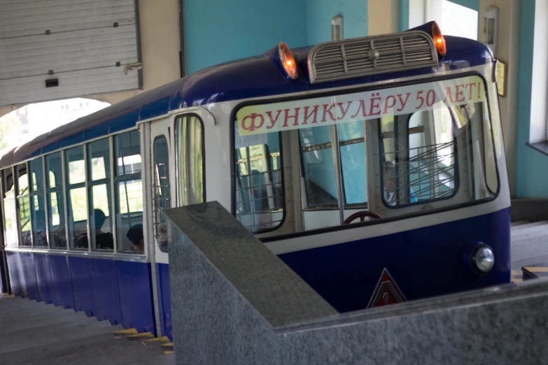 an old bus with advertising is parked inside a building