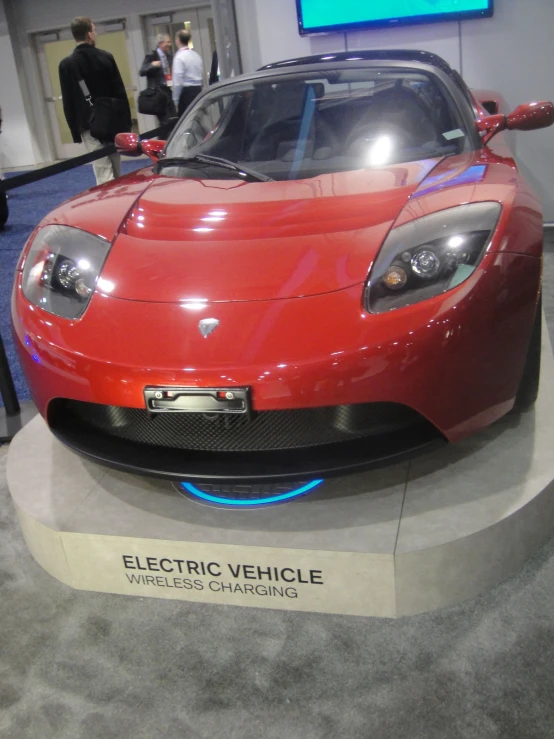 a bright red sports car sitting on display