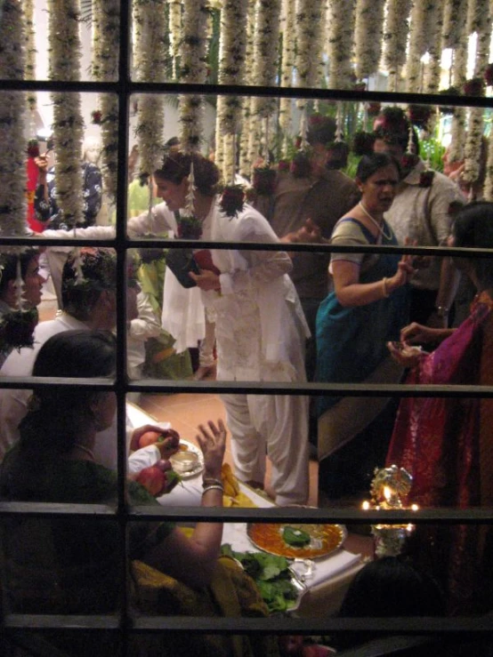 some people standing and eating at some tables