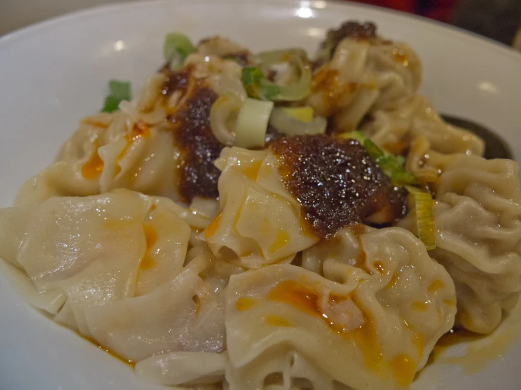 a plate with dumplings on top and some vegetables