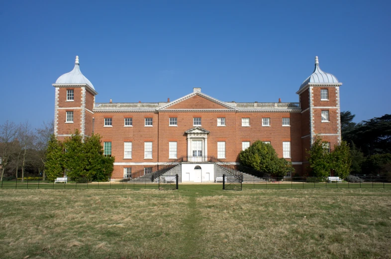 the large red brick building has many windows