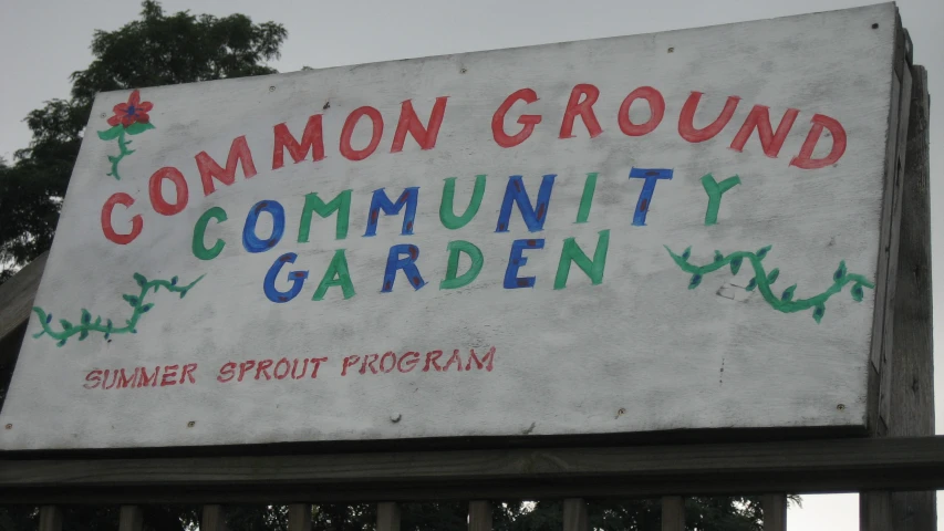 a sign that says common ground community garden