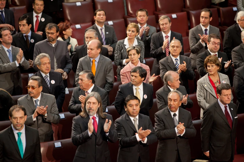 group of people with many clapping hands in front of them