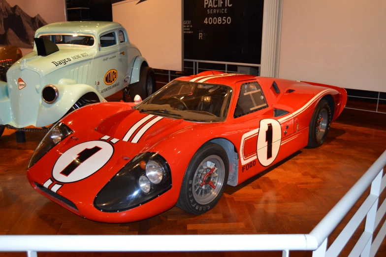 a close up of two classic race cars on display