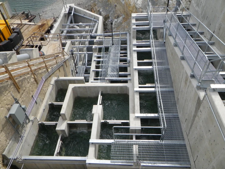 a cement and steel structure that is surrounded by water