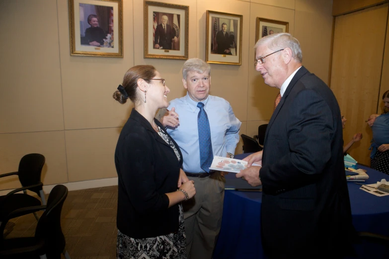 two men in business attire and two women at a table