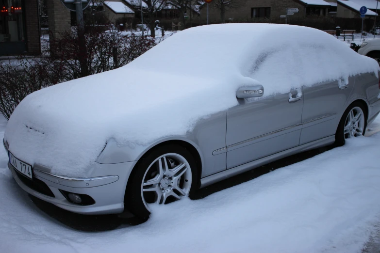 the car is covered in snow after a blizzard