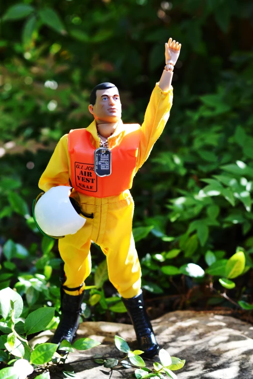 a statue of a man with his arms up and holding a frisbee