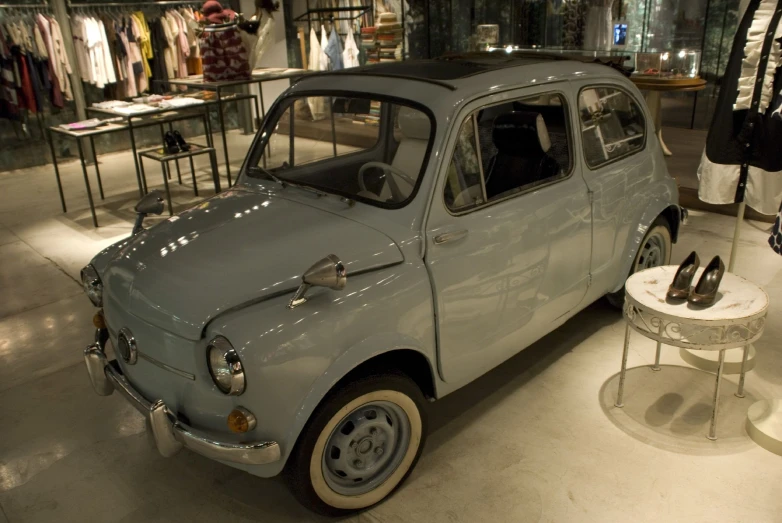 a small car parked in front of a shop