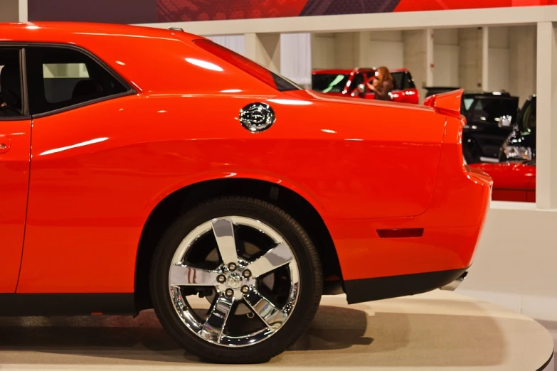 a red car on display inside a showroom