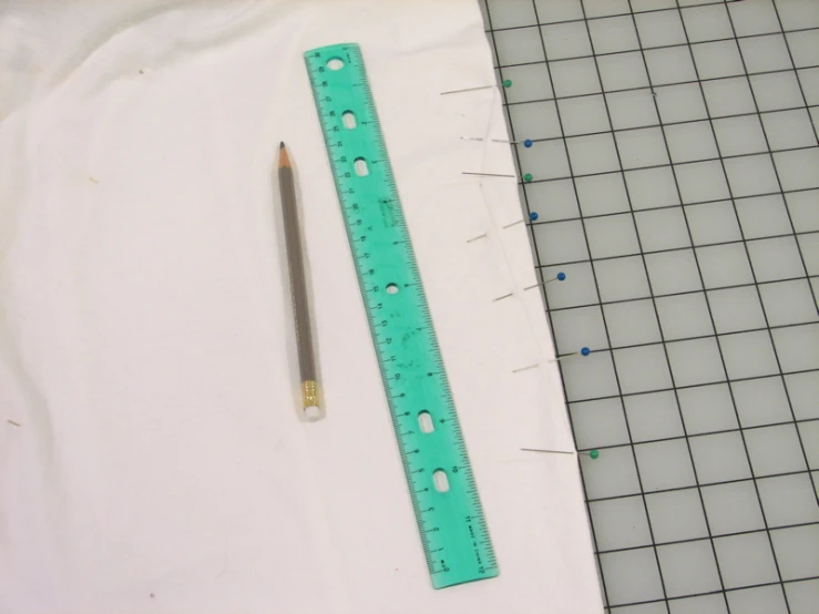 the ruler has a plastic handle with holes in it