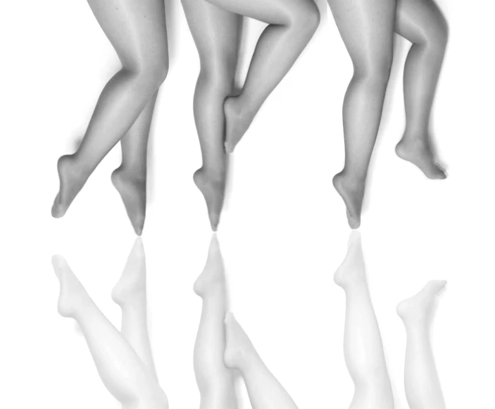 a black and white po of woman legs and heels