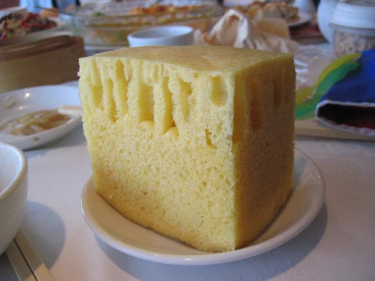 a slice of yellow cake on a plate