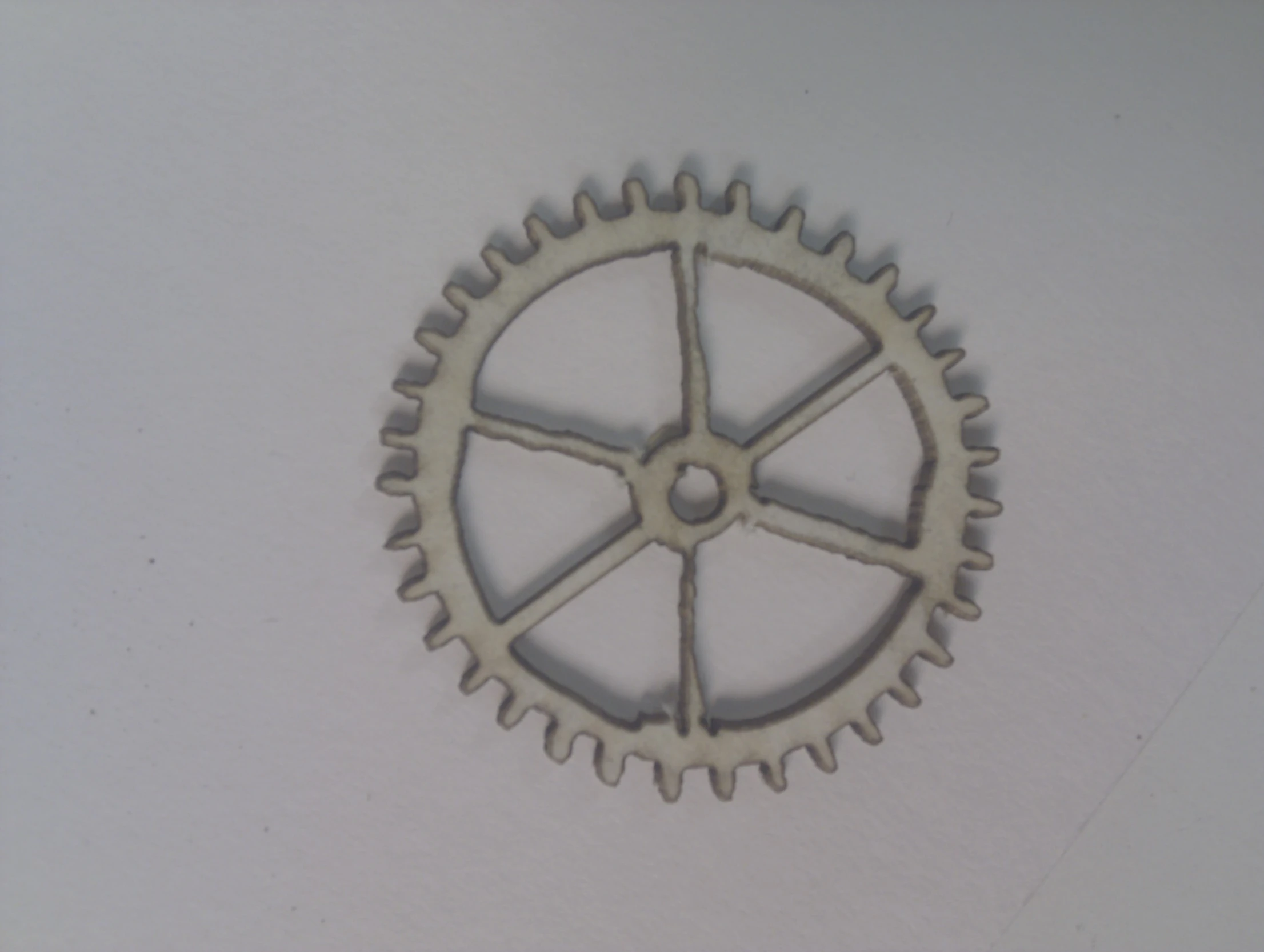 a close up of the side of an object, with two gears