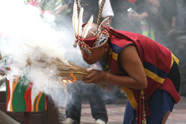 a person in a costume is lighting incenses