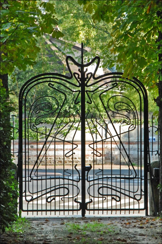 an intricate wrought iron gate with a woman on the head and neck