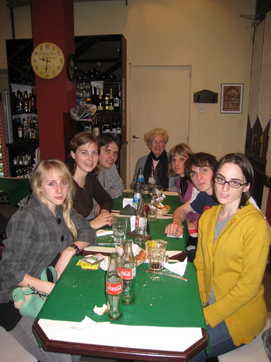 a group of people sitting at a dinner table