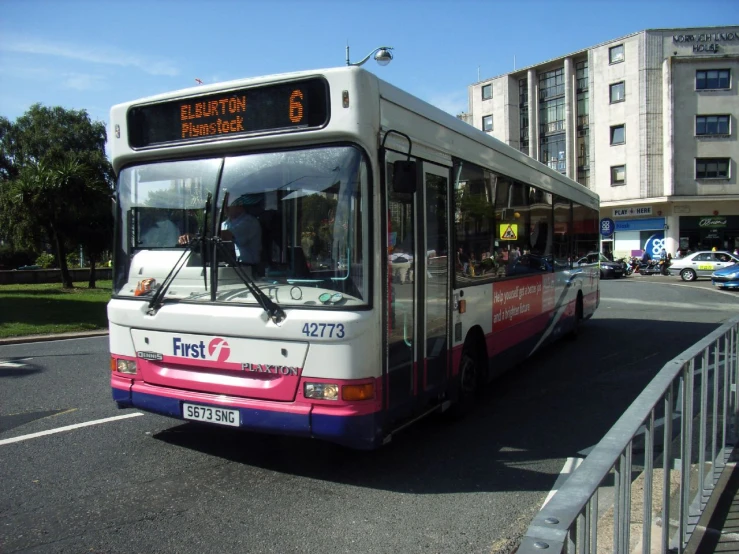 a bus is traveling down the street in a foreign country