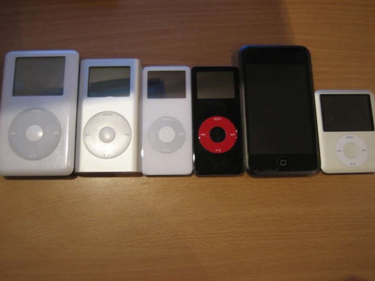 four ipods lined up together in a row