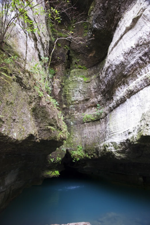 an image of a cave that is on the mountains