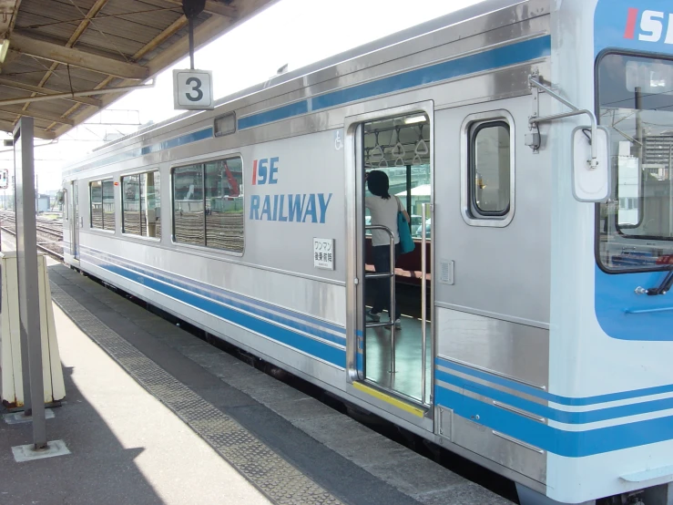 a passenger train sitting at a station loading passengers