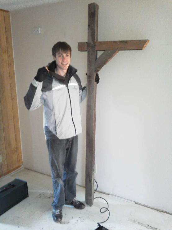 there is a person standing next to a cross