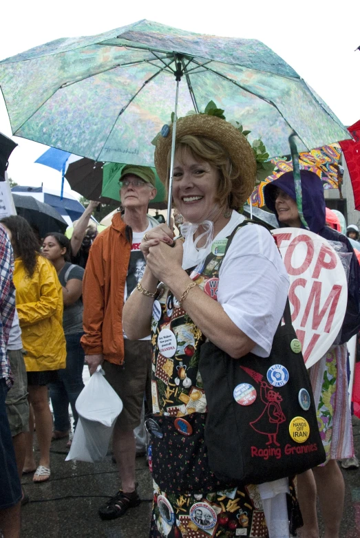 a woman carrying an umbrella in the street