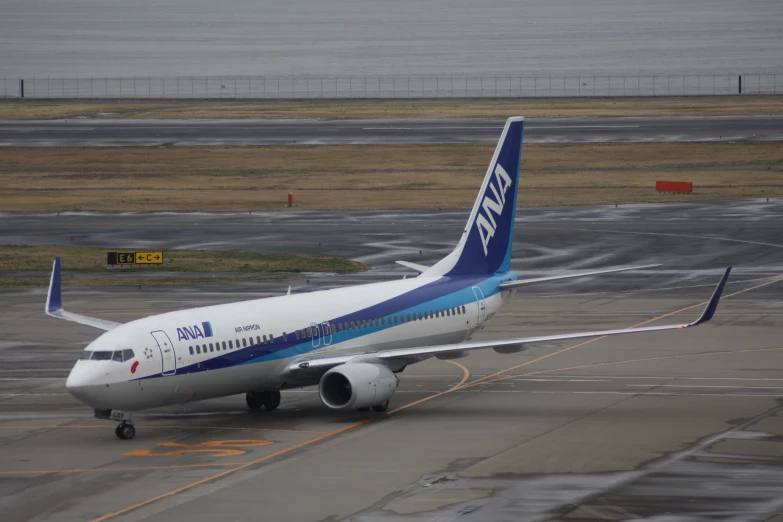 an airplane with blue stripes is sitting on the runway