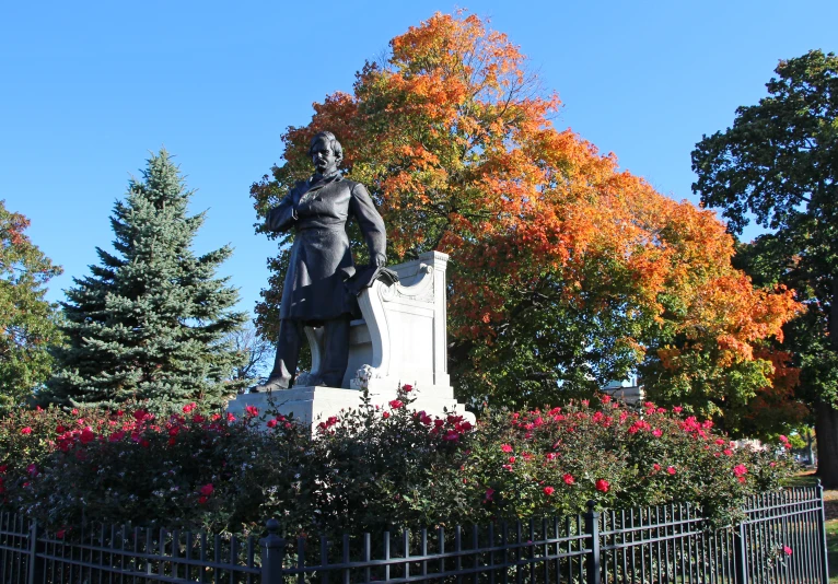 the statue of aham lincoln is in front of colorful trees