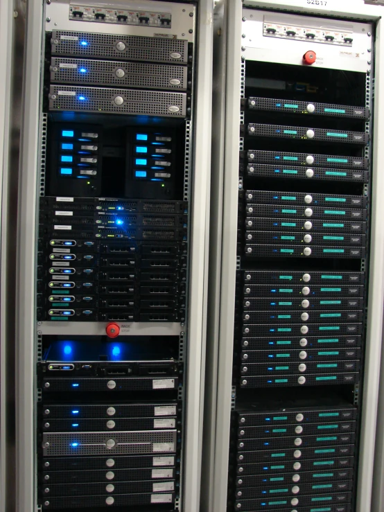 multiple rows of computers in a large computer room