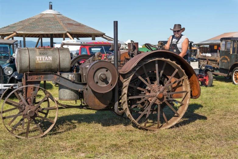 an old tractor sitting in a grassy field