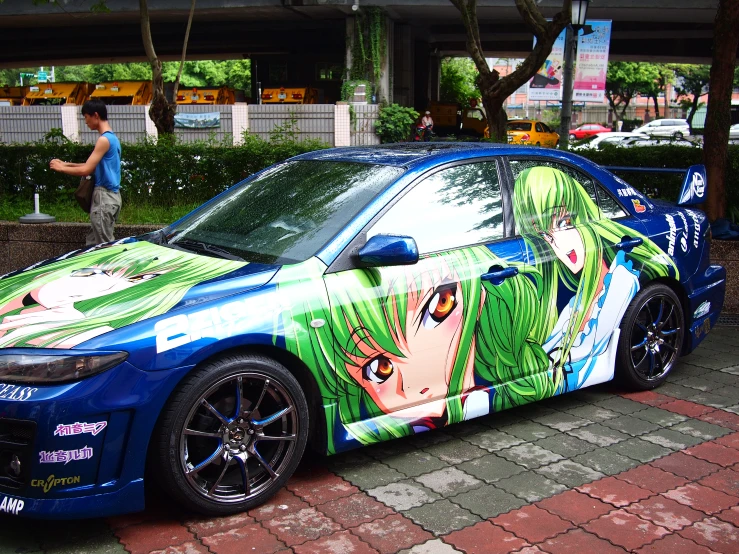 a blue car has a anime themed wrapper on it