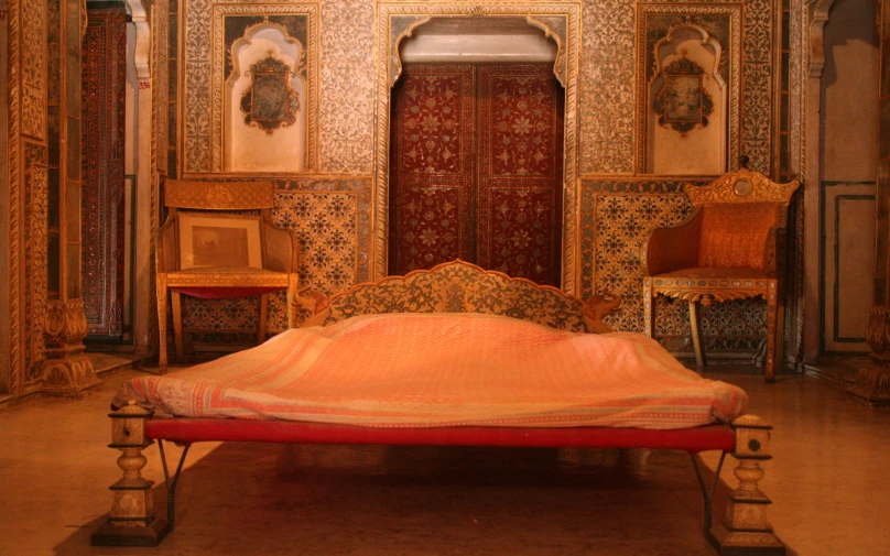 a large bed sitting inside of a room on top of a hard wood floor