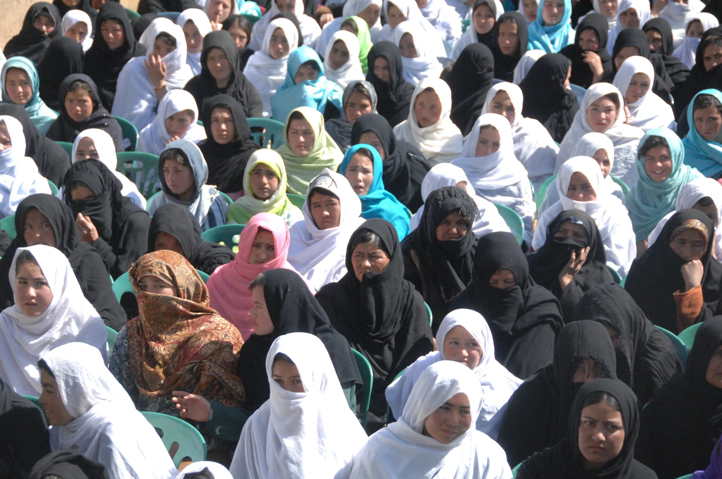 a group of women dressed in hijabs on their cell phones