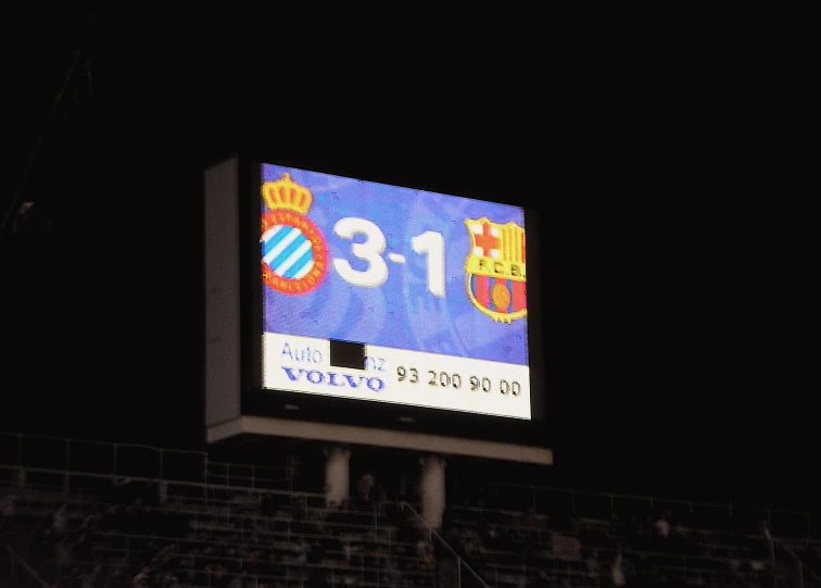 the electronic score board on the side of a soccer stadium