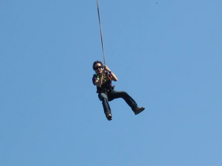 a person is kiteboarding over the sky on a sunny day