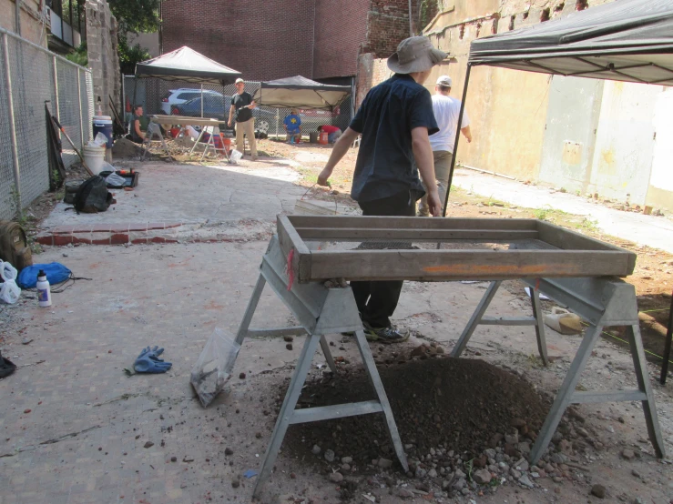 a man walking away from a table that he is holding up