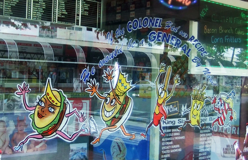 storefront window of an asian grocery store with cartoon images on them