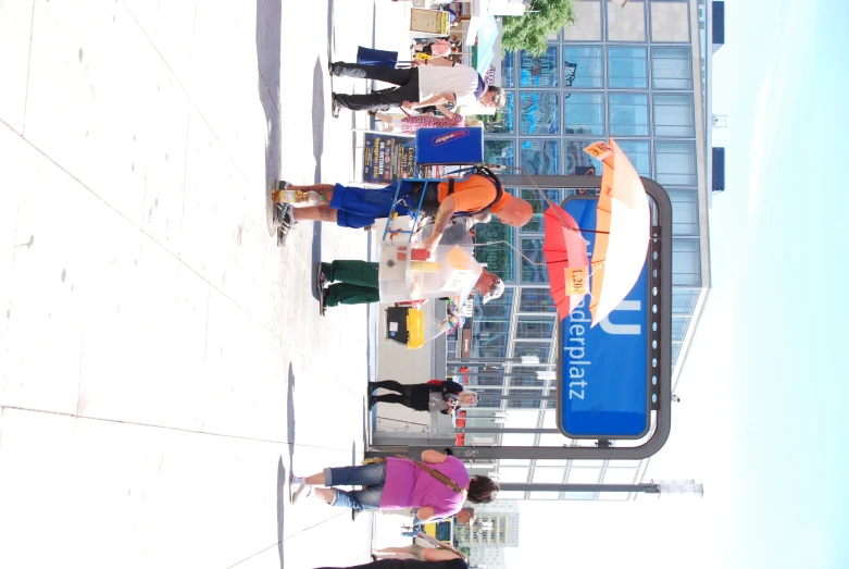 people stand under a canopy with open umbrellas