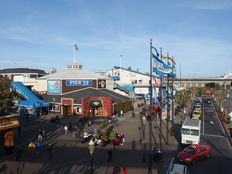 many people and cars in a busy city street