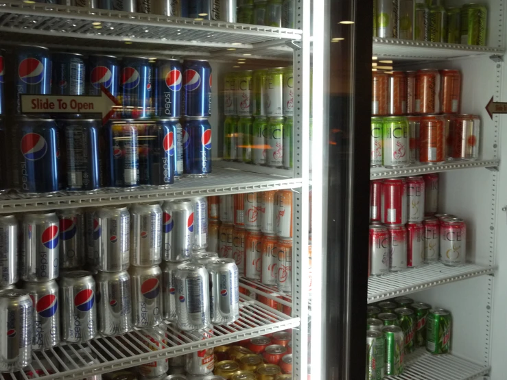 a refrigerator full of cans of drinks and cans