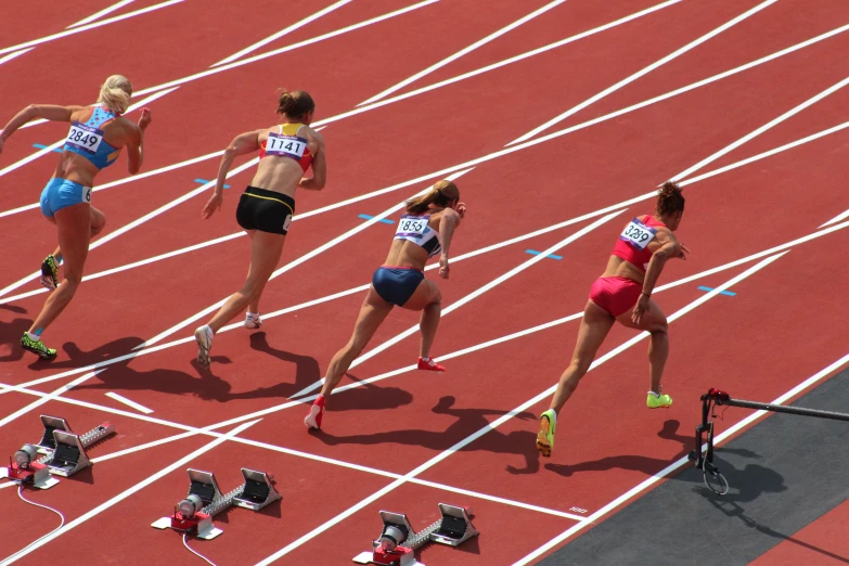 a group of women on the track with different outfits