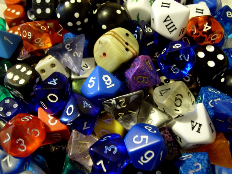 several colored dice sitting in a pile together
