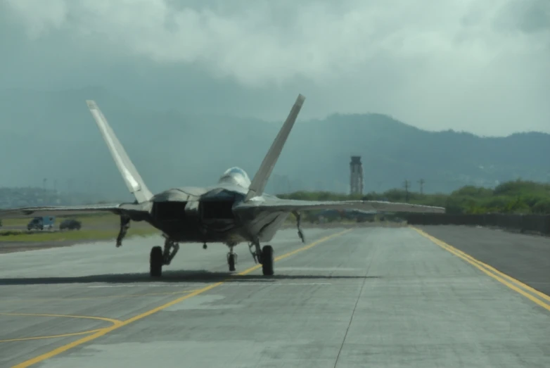 a fighter jet is sitting on the runway