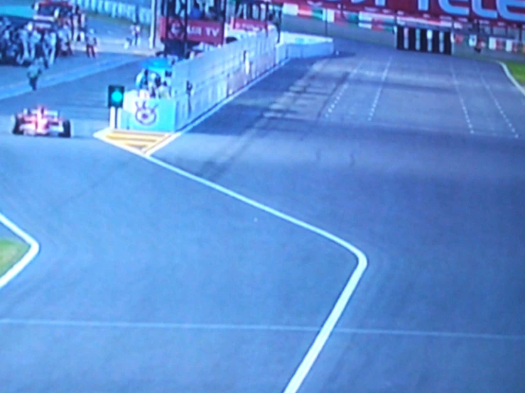 a motorcyclist is on a racing track with people watching