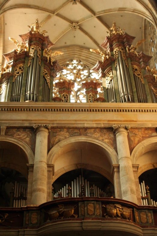 an old church has an organ and arched ceilings