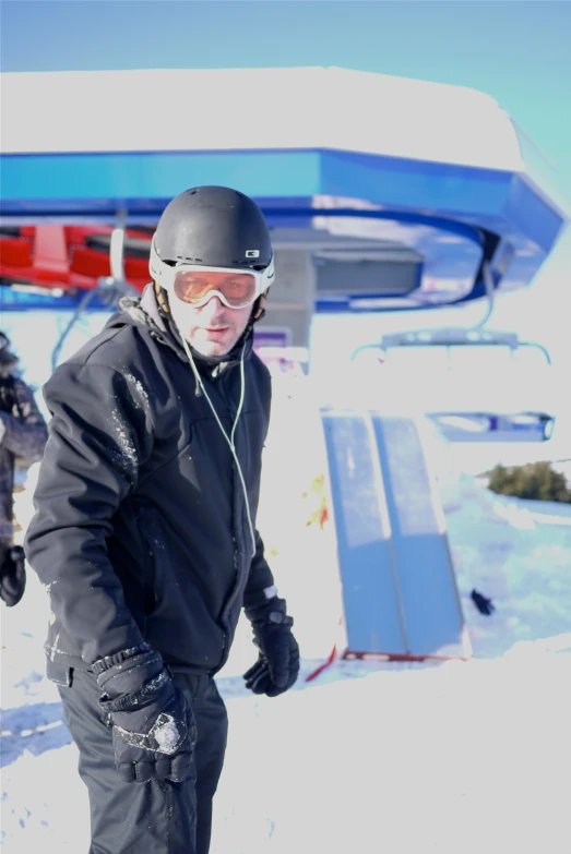 a man riding a snowboard on top of a snow covered slope